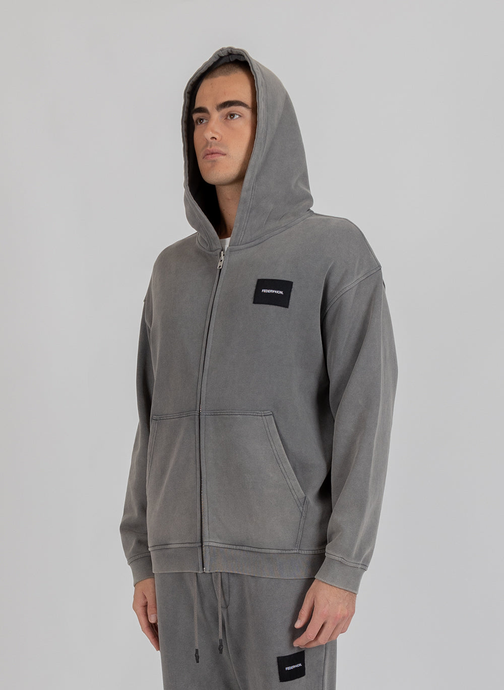 Axel Zip Up - Woven Badge