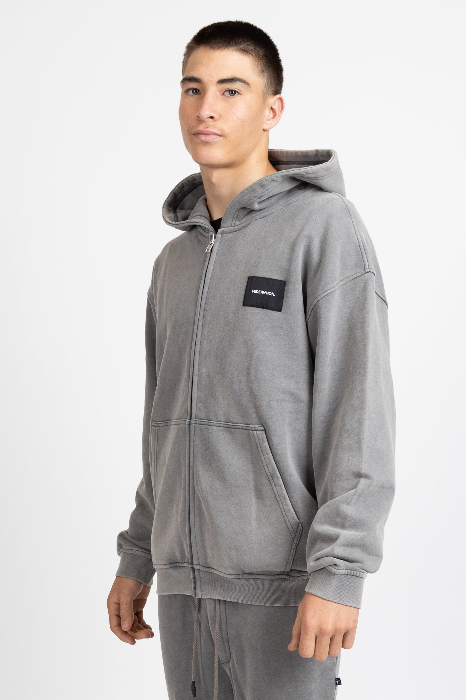 Axel Zip Up - Woven Badge